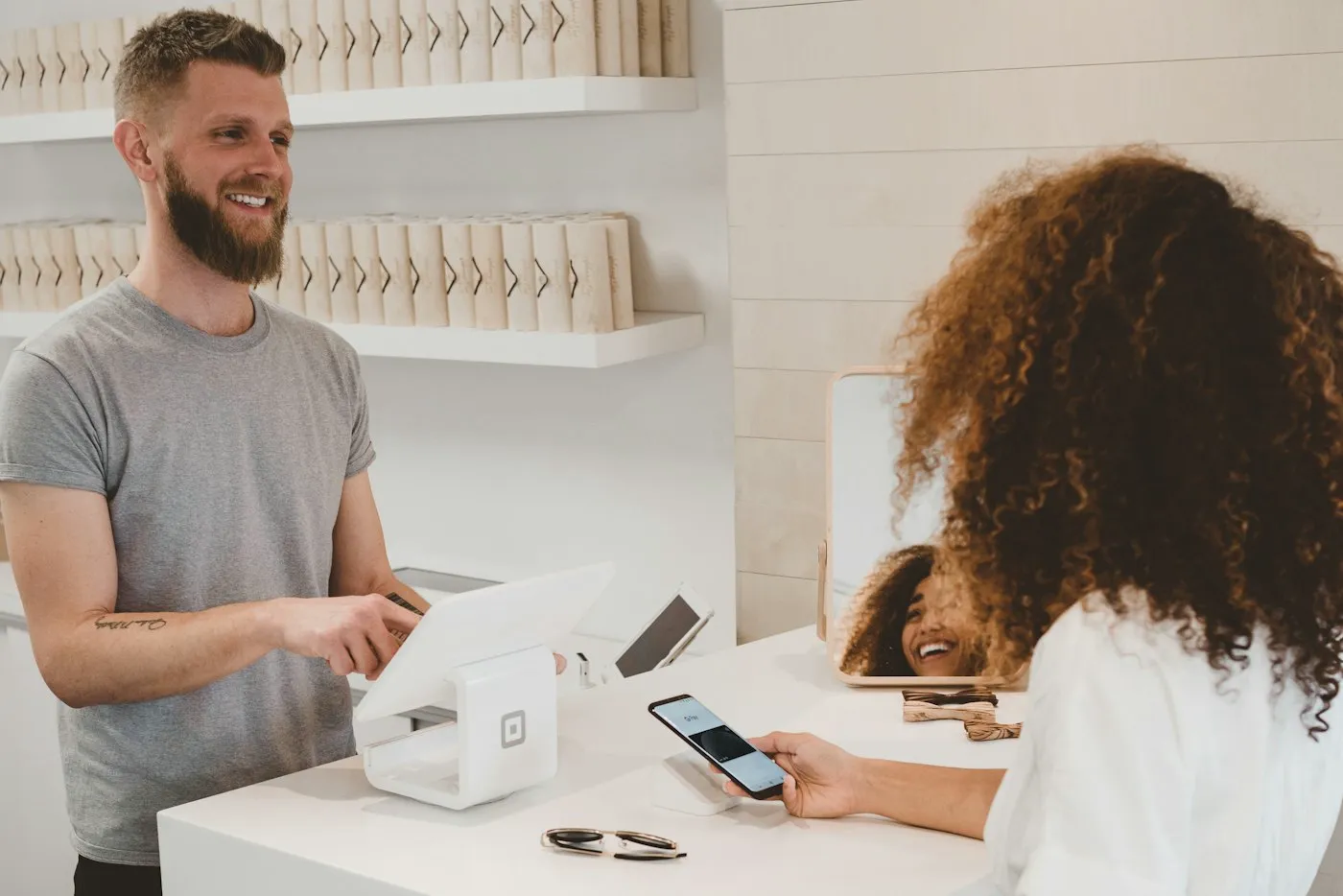 A buyer paying at a shop counter